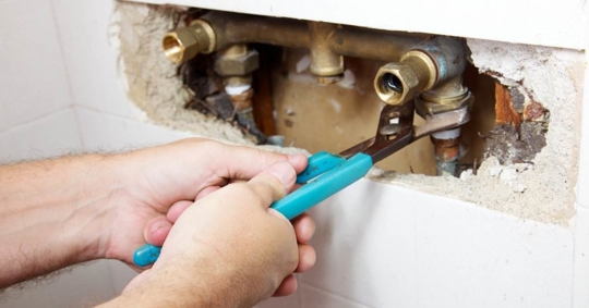 Plumber repairing shower leak
