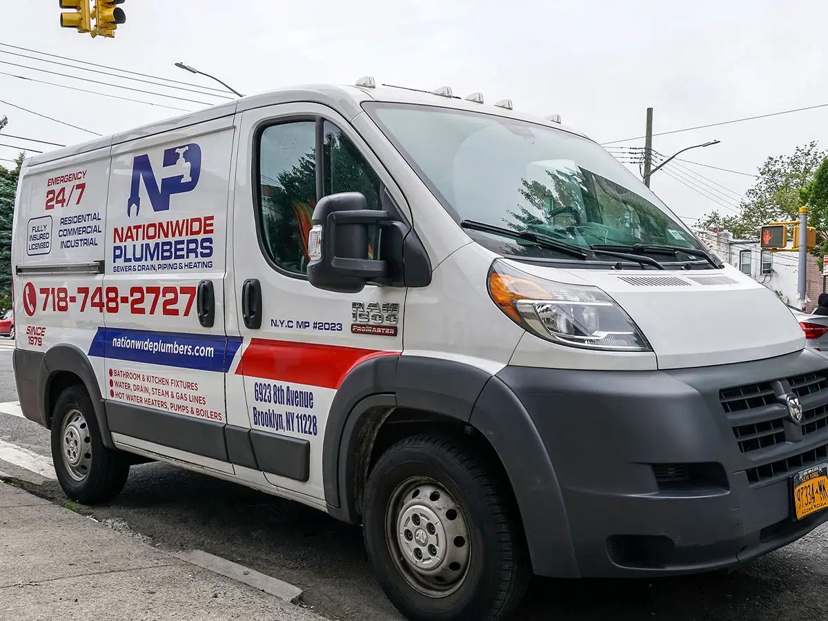A white van with "Nationwide Plumbers" signage on the side is parked.
